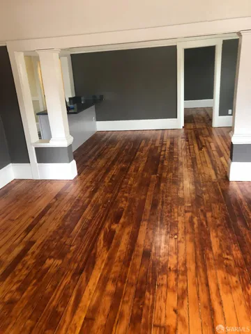 a white kitchen with sink a stove and a refrigerator