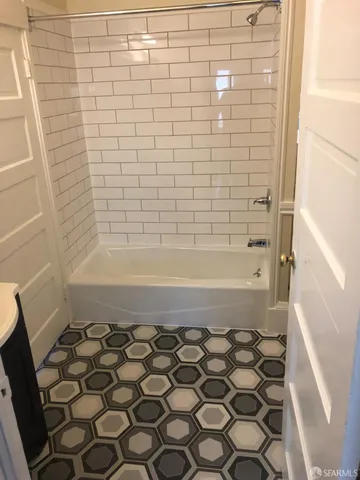 a bathroom with a bathtub and shower