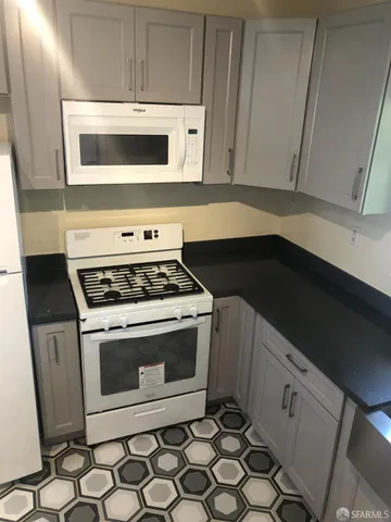 a stove top oven sitting inside of a kitchen