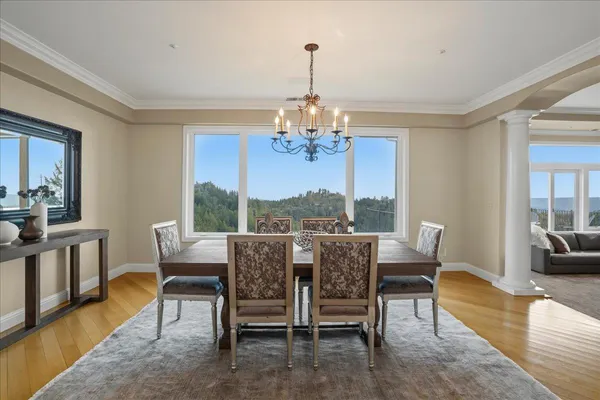a view of a kitchen with kitchen island granite countertop wooden floors and a view of living room