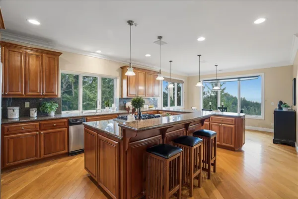 a kitchen with granite countertop a sink and a window