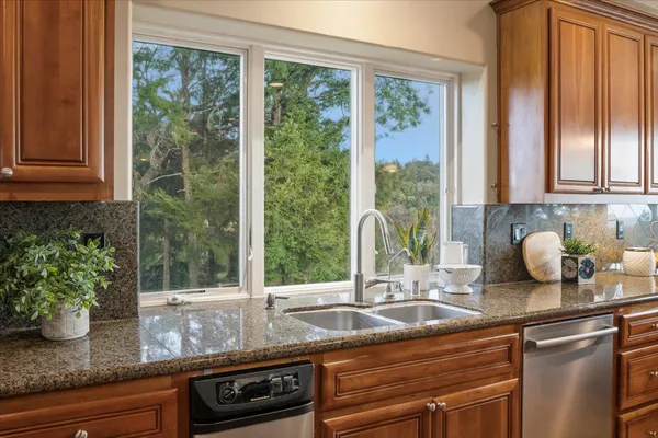 a kitchen with stainless steel appliances granite countertop stove top oven and cabinets