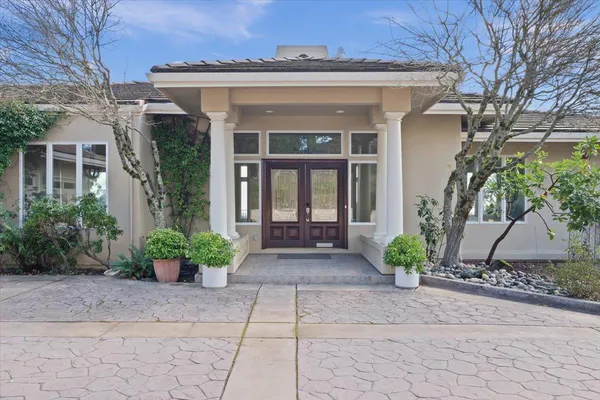 a front view of a house with garden