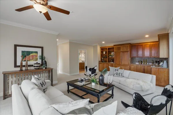 a dining room with furniture and a floor to ceiling window