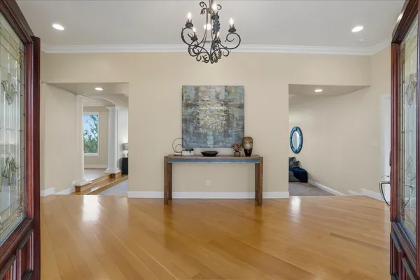 a view of a room with wooden floor and large windows