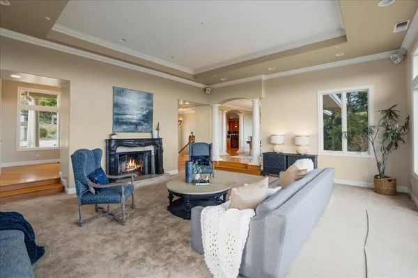 a living room with furniture a fireplace and window