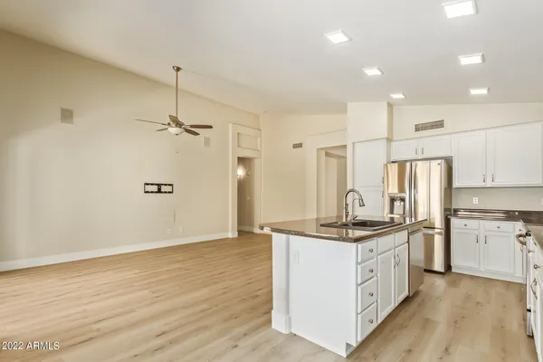 a kitchen with stainless steel appliances granite countertop a sink stove and refrigerator