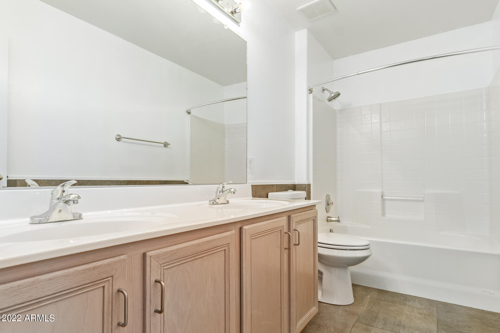 1647 East Heather Avenue Gilbert, AZ 85234 - Photo 21 of 27 a bathroom with a granite countertop sink a toilet and a bathtub