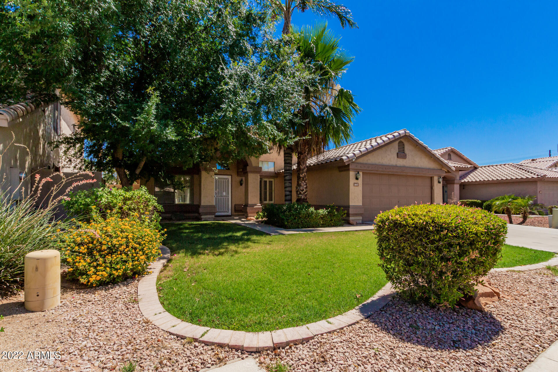 1647 East Heather Avenue Gilbert, AZ 85234 - Photo 3 of 27 a front view of a house with garden