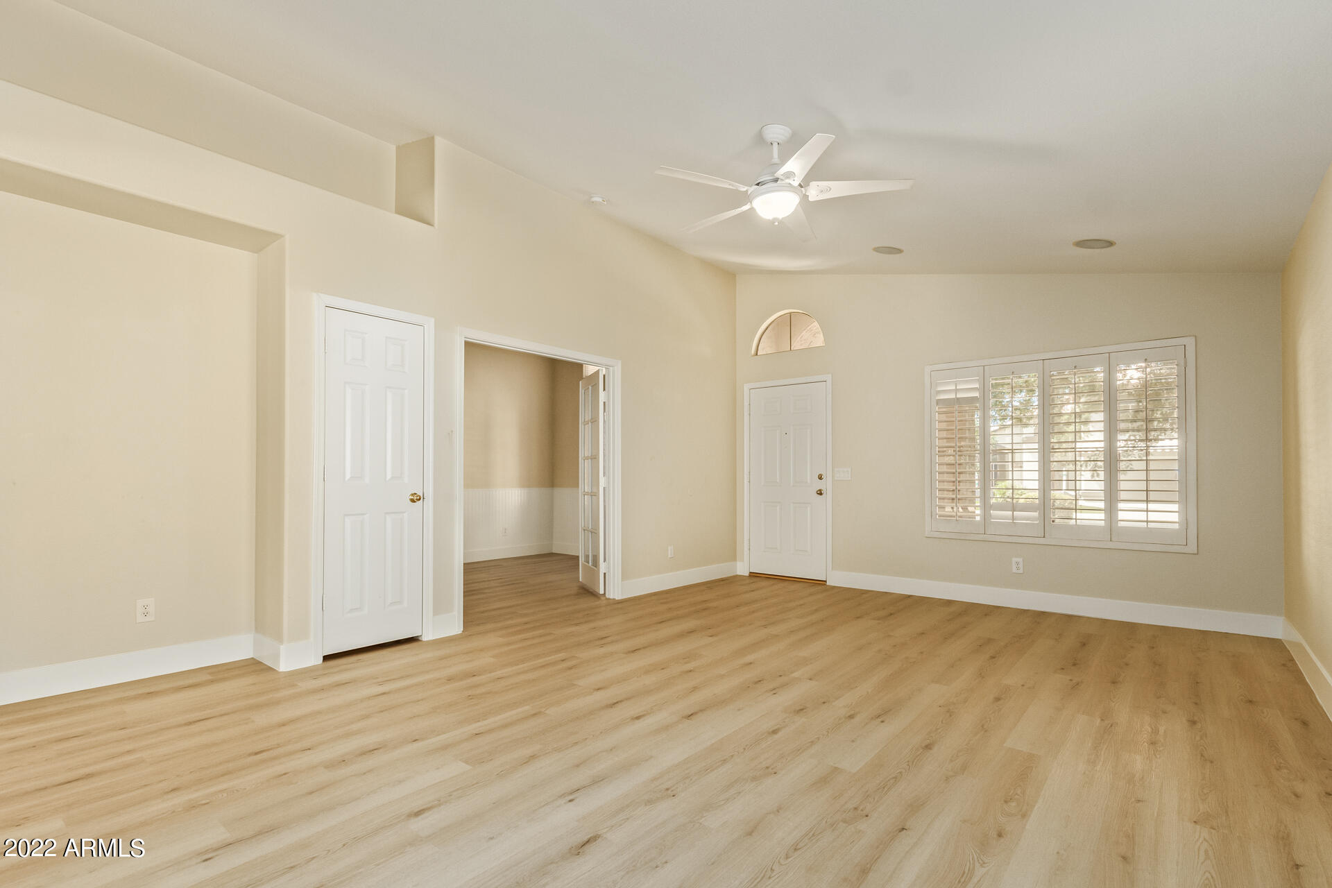 1647 East Heather Avenue Gilbert, AZ 85234 - Photo 4 of 27 a view of an empty room with wooden floor and a window