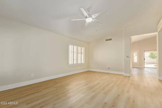 wooden floor in an empty room with a window