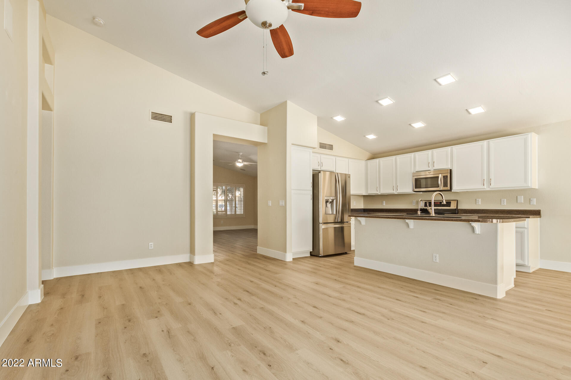 1647 East Heather Avenue Gilbert, AZ 85234 - Photo 10 of 27 a view of kitchen with stainless steel appliances refrigerator stove microwave and white cabinets