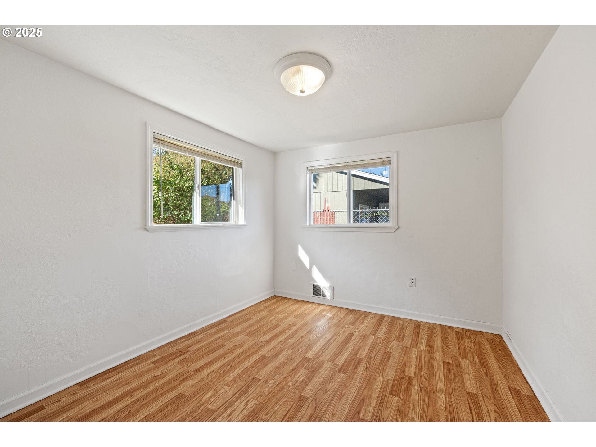 1917 Scott Road Springfield, OR 97477 - Photo 19 of 31 a view of an empty room with wooden floor and a window