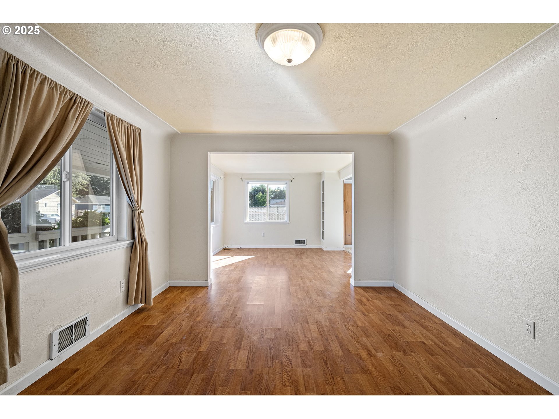 1917 Scott Road Springfield, OR 97477 - Photo 4 of 31 a view of an empty room with a window and wooden floor