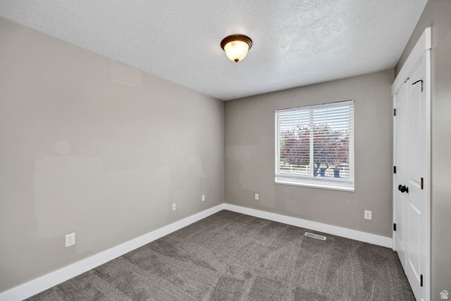 2912 South 1080th Street West Logan, UT 84321 - Photo 5 of 43 Room featuring neutral gray wall paint, white trim, and gray patterned carpeting