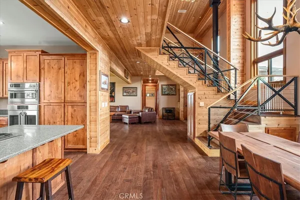 a kitchen with stainless steel appliances granite countertop a refrigerator and wooden cabinets