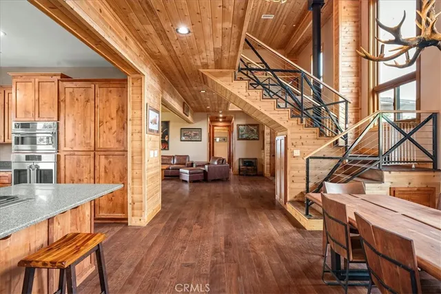 a kitchen with stainless steel appliances granite countertop a refrigerator and wooden cabinets