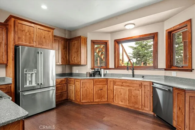 a bathroom with a granite countertop sink toilet mirror and shower