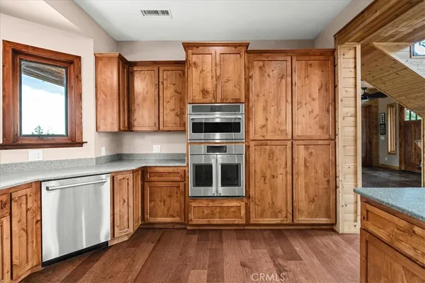 a bathroom with a granite countertop sink toilet mirror and shower