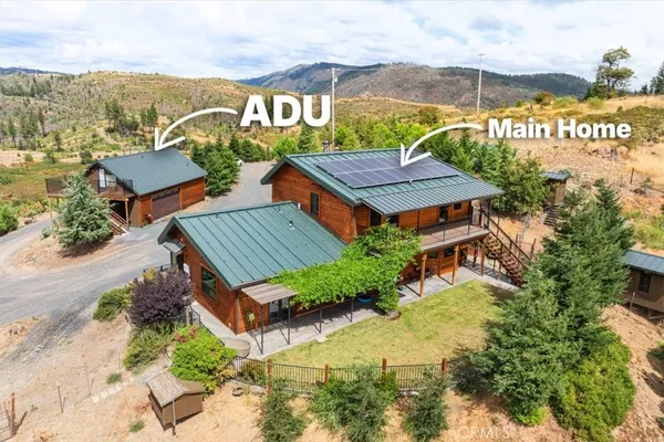 an aerial view of a house a garden and lake view