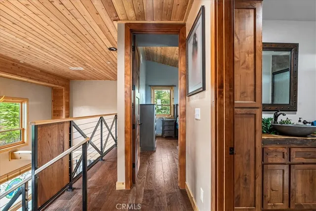 a bed sitting in a spacious bedroom next to a window