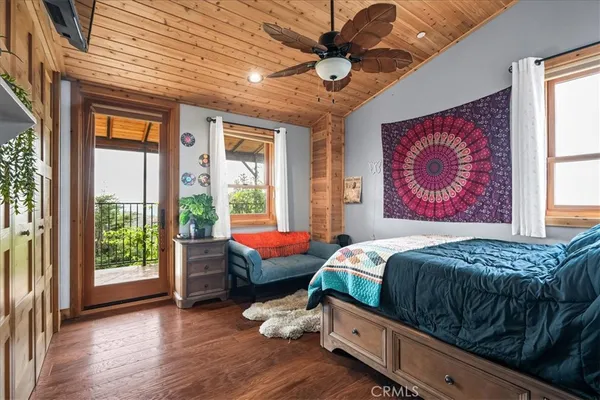 a bed sitting in a spacious bedroom next to a window