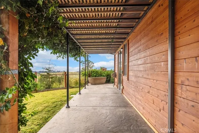 a view of a backyard with wooden fence