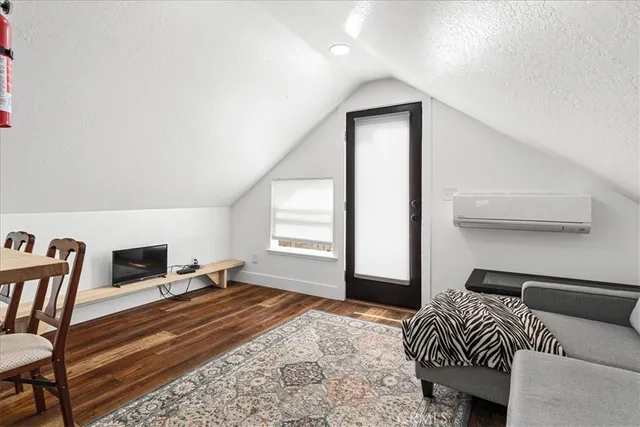 an aerial view of a house with a yard and lake view