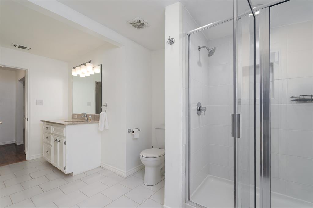 809 Turner Lane Tuscola, TX 79562 - Photo 14 of 25 Bathroom featuring vanity, a shower stall, and tile patterned flooring