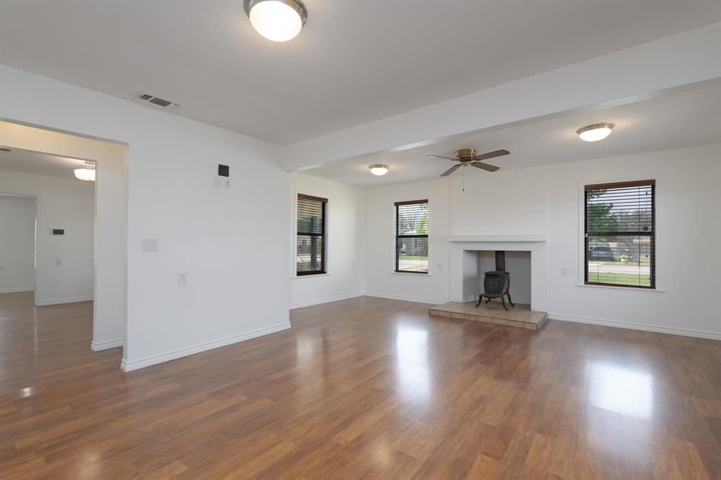 809 Turner Lane Tuscola, TX 79562 - Photo 20 of 25 Unfurnished living room with wood finished floors and ceiling fan