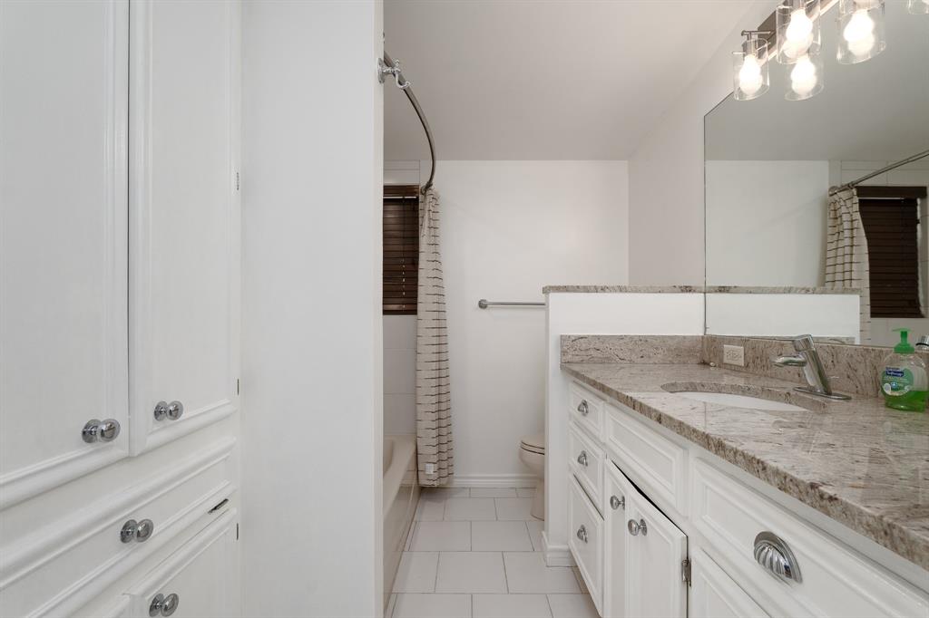 809 Turner Lane Tuscola, TX 79562 - Photo 8 of 25 Bathroom featuring vanity, tile patterned floors, and shower / bath combination with curtain