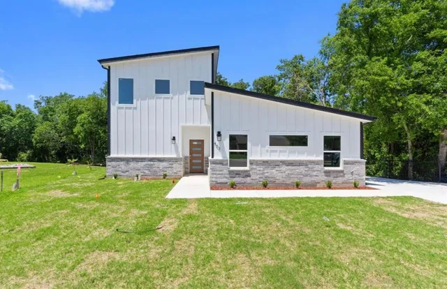 a front view of house with yard and outdoor seating