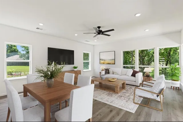 a living room with furniture potted plant and a large window