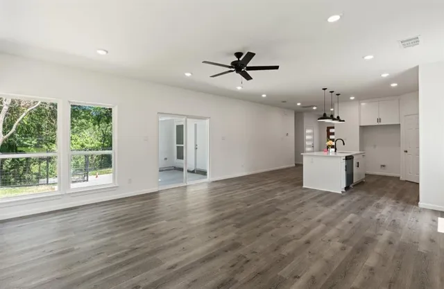a kitchen with a refrigerator and white cabinets