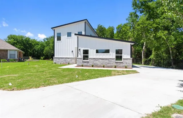 a view of a house with backyard and sitting area