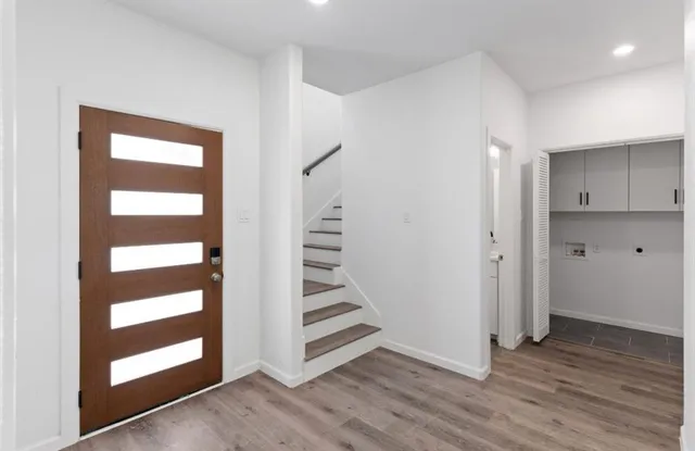 a view of a room with wooden floor and windows