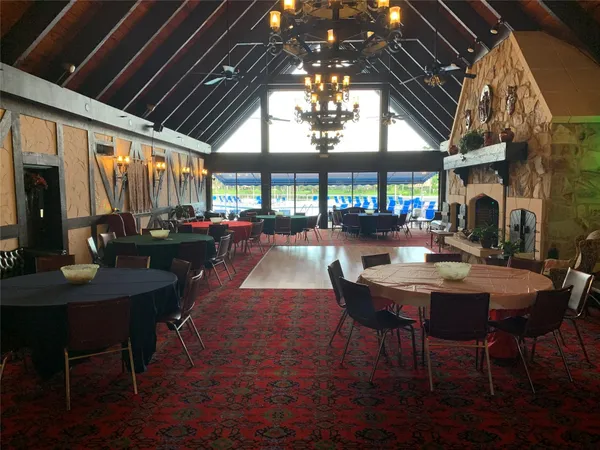 a dining room with lots of furniture and a chandelier