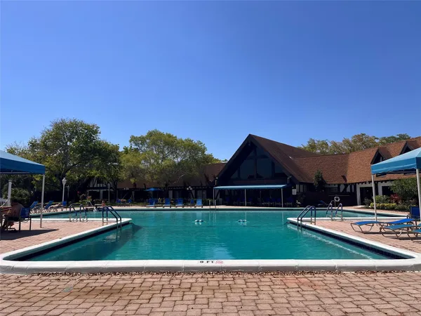 a view of swimming pool and outdoor seating