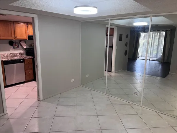 a view of a kitchen with an empty space and a window