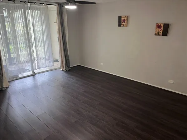 a view of wooden floor and brick walls