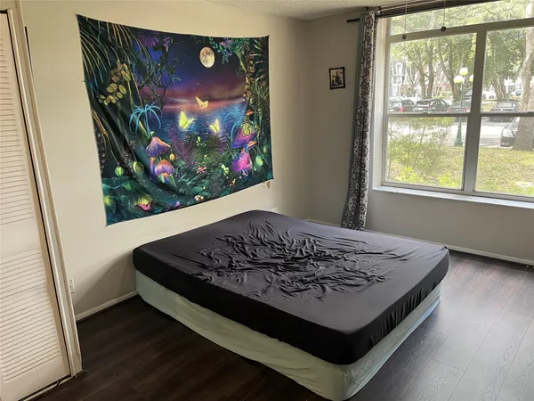 a bed sitting in a bedroom next to a window