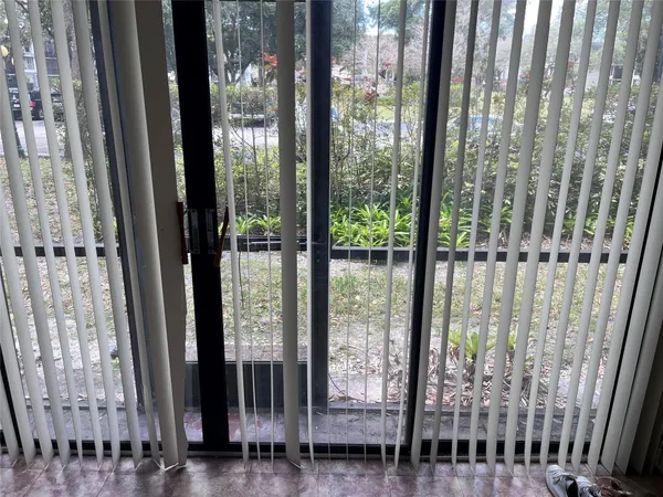 a view of a porch with a floor to ceiling window