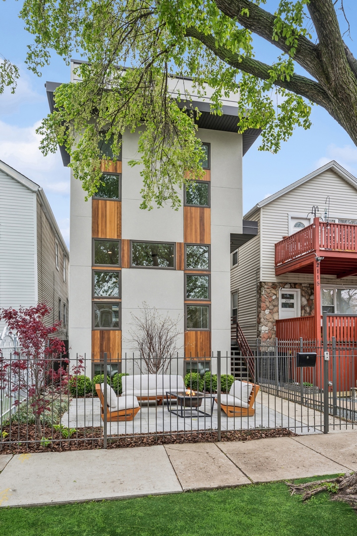 a view of a chairs and table in the backyard