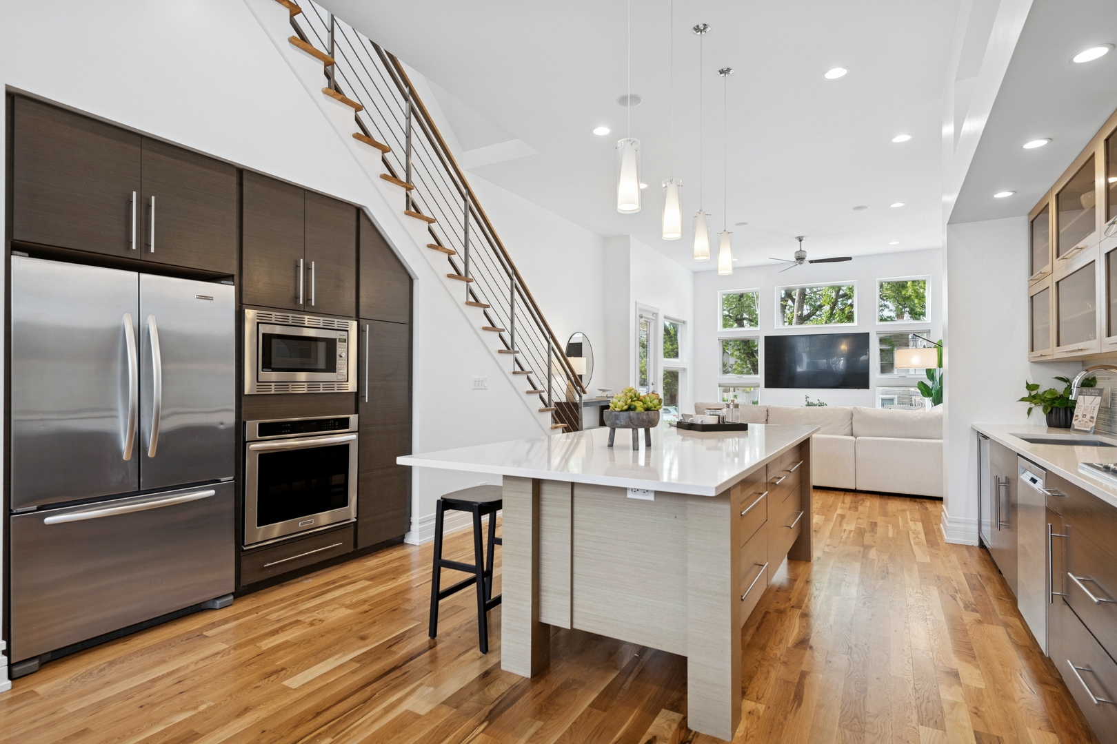 2113 West Huron Street Chicago, IL 60612 - Photo 14 of 49 a kitchen with stainless steel appliances kitchen island granite countertop a refrigerator a stove and a wooden floors