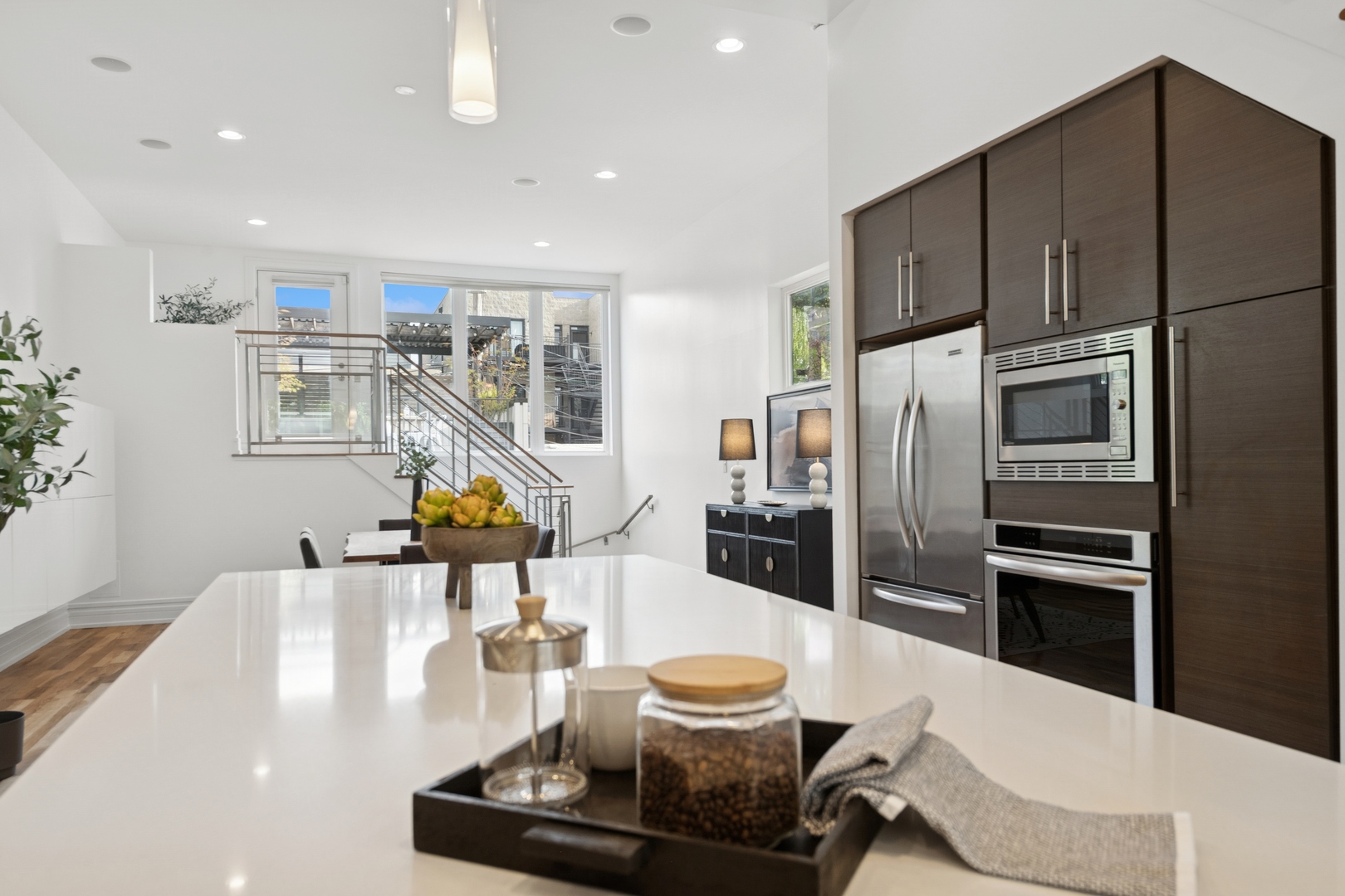 2113 West Huron Street Chicago, IL 60612 - Photo 16 of 49 a kitchen with stainless steel appliances wooden floor dining table and chairs