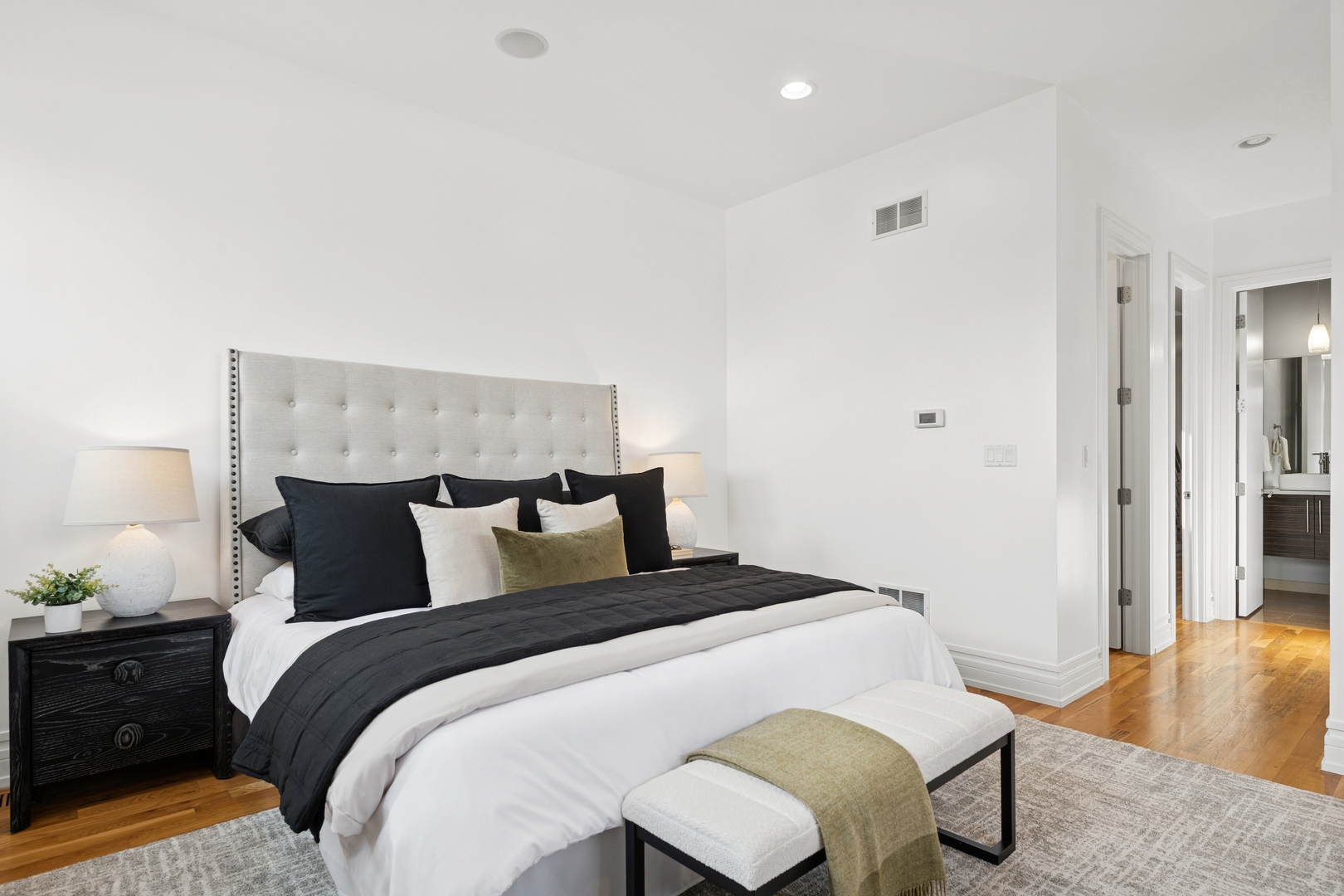 2113 West Huron Street Chicago, IL 60612 - Photo 26 of 49 a bedroom with a bed and wooden floor