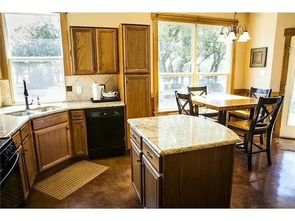 a kitchen with a sink stove and dining table