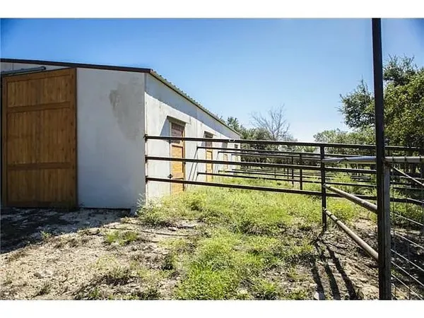 a view of backyard with wooden fence