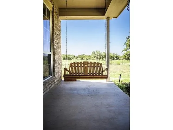 a view of a porch with a floor to ceiling window