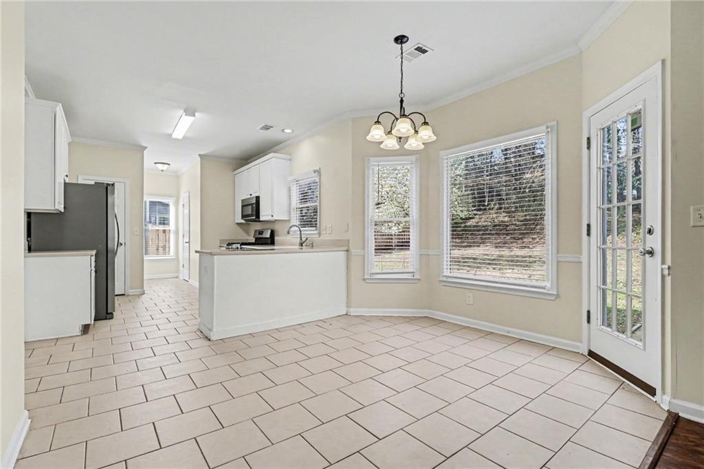 7170 Threadstone Overlook Duluth, GA 30097 - Photo 11 of 26 a view of a kitchen with microwave and refrigerator